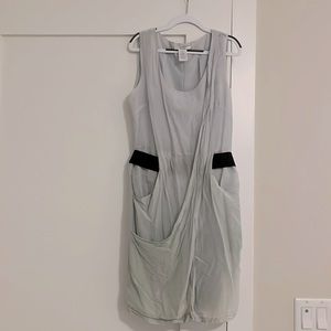 Linen sleeveless dress with elastic black belt and pockets. Hits above knee.